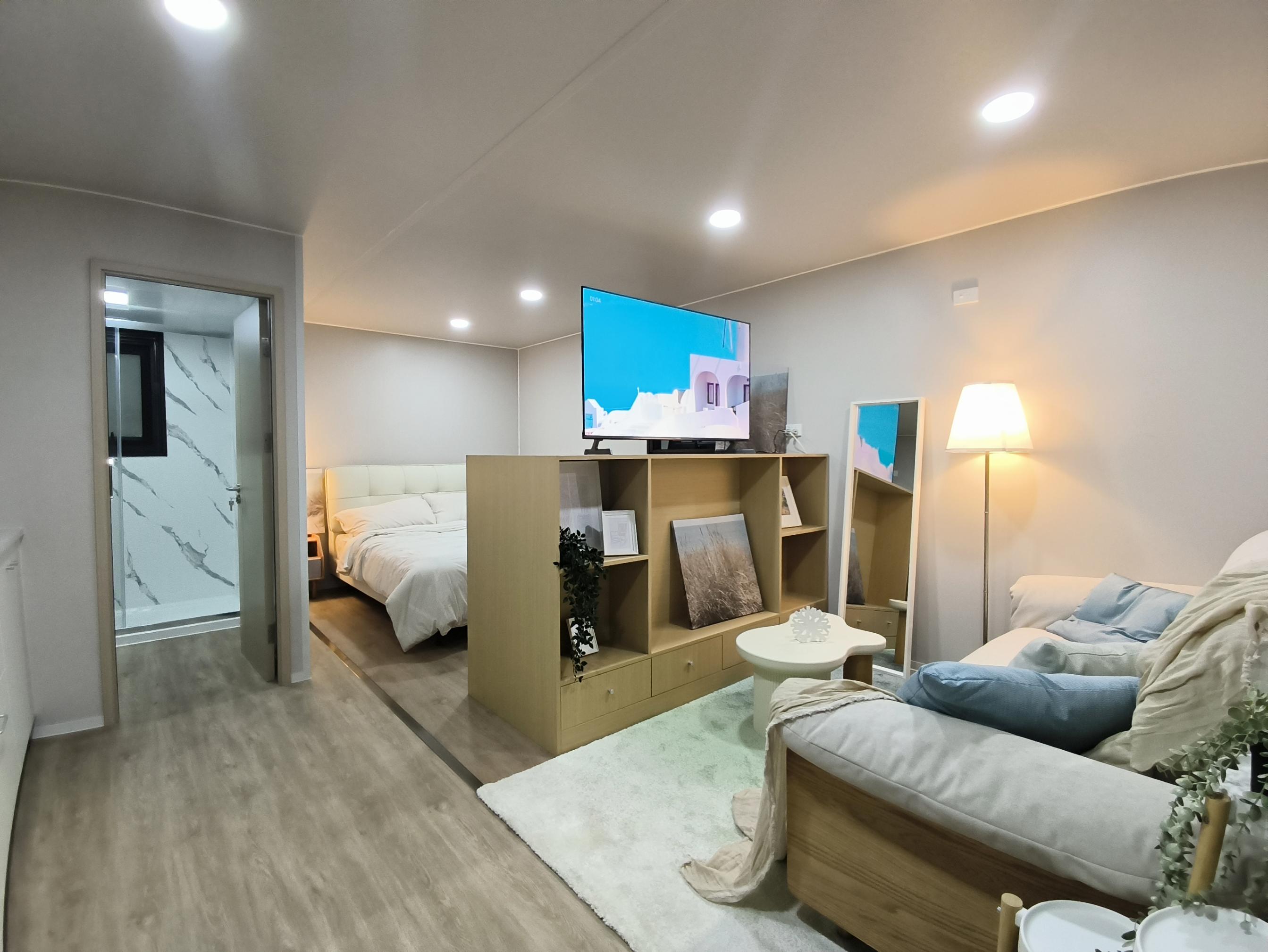 Compact bedroom and living space inside a PrefabX Flip Mini